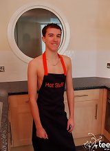 Handsome twink dressed only in apron plays with his cock in the kitchen